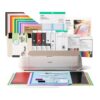 Cricut cutting machine with colorful papers vinyl and craft supplies arranged behind it for DIY projects