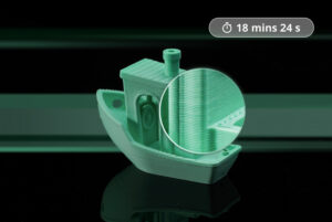 Green 3D printed boat with a magnified close up showing layered print lines at the side view