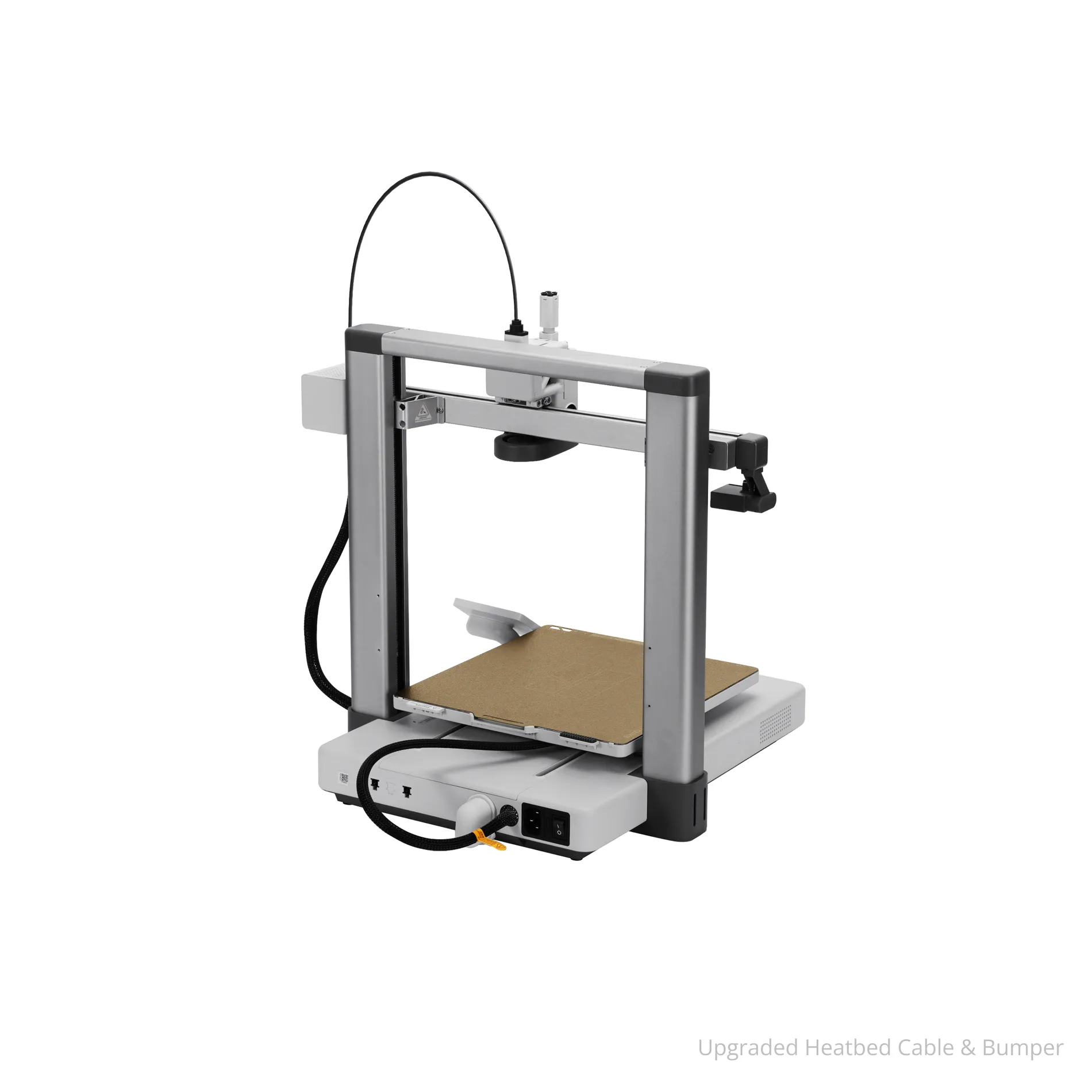 3D printer with a silver frame and brown build plate showing an upgraded heatbed cable and bumper at the base